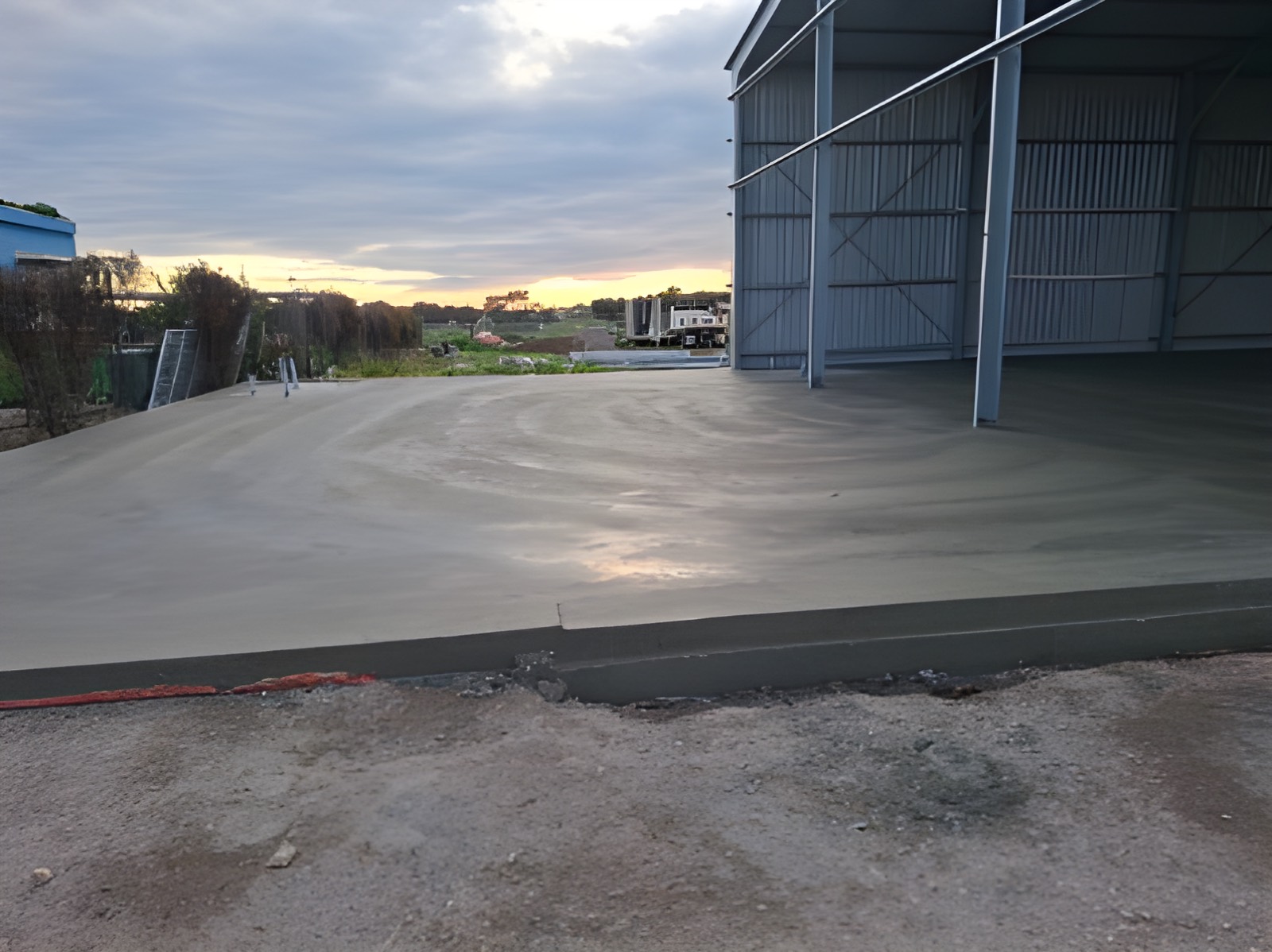 Large shed slab and apron freshly poured at sunset