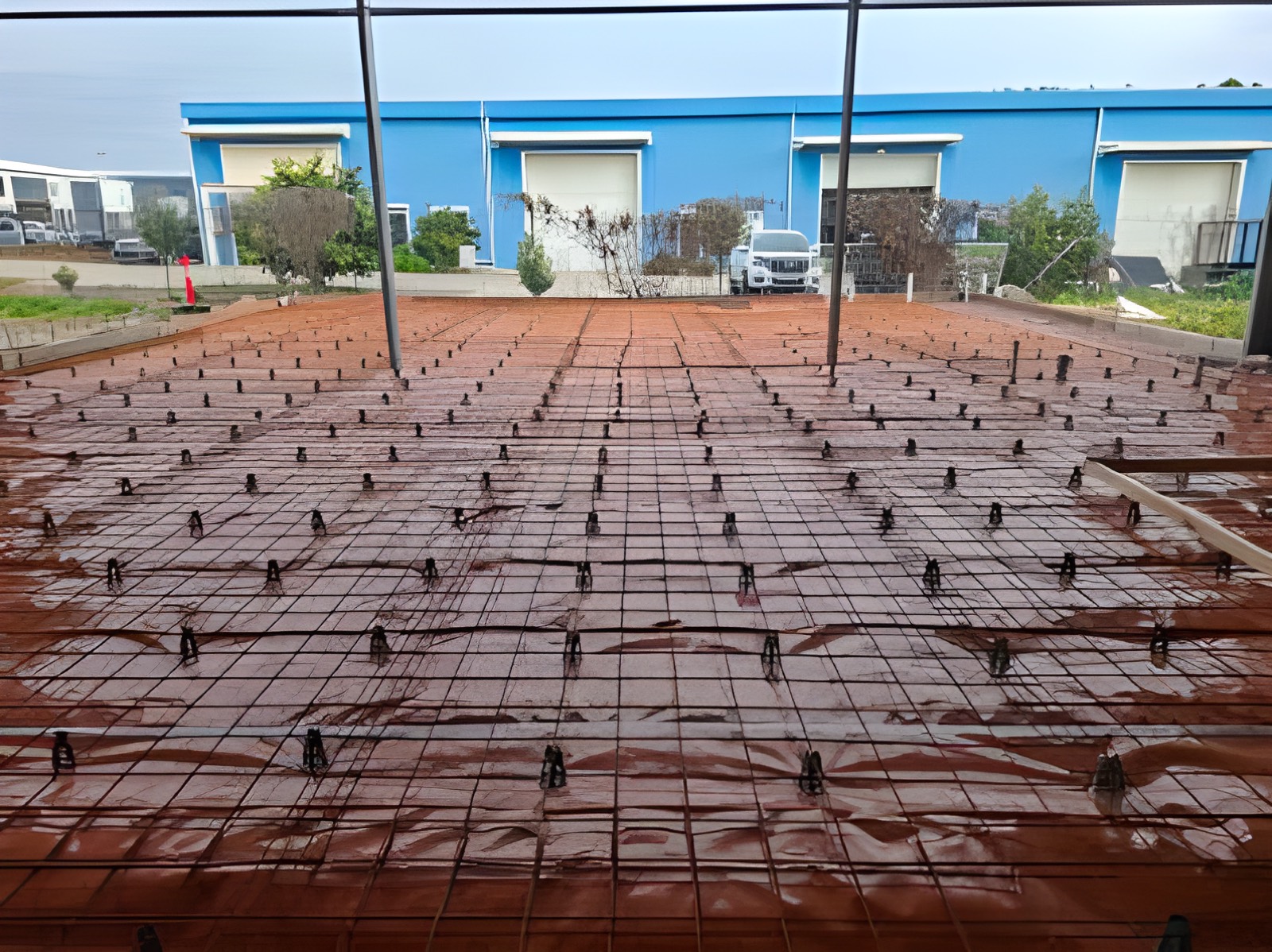 Commercial yard slab prepared with steel mesh on bar chairs